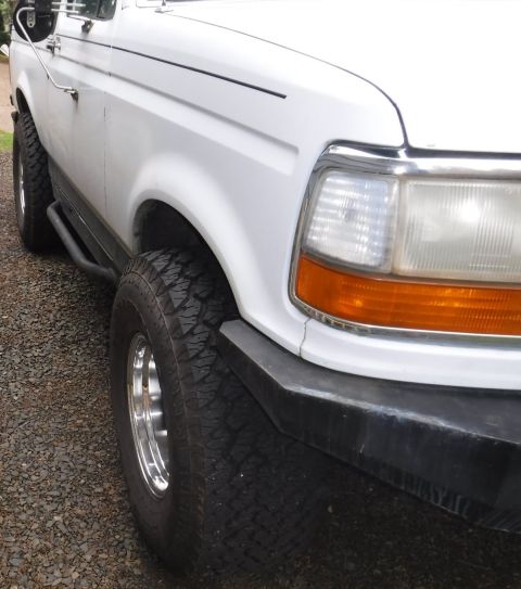 1992 Ford Bronco - New 15x10 wheels, Pro Comp 69 / 1069, front angled view.