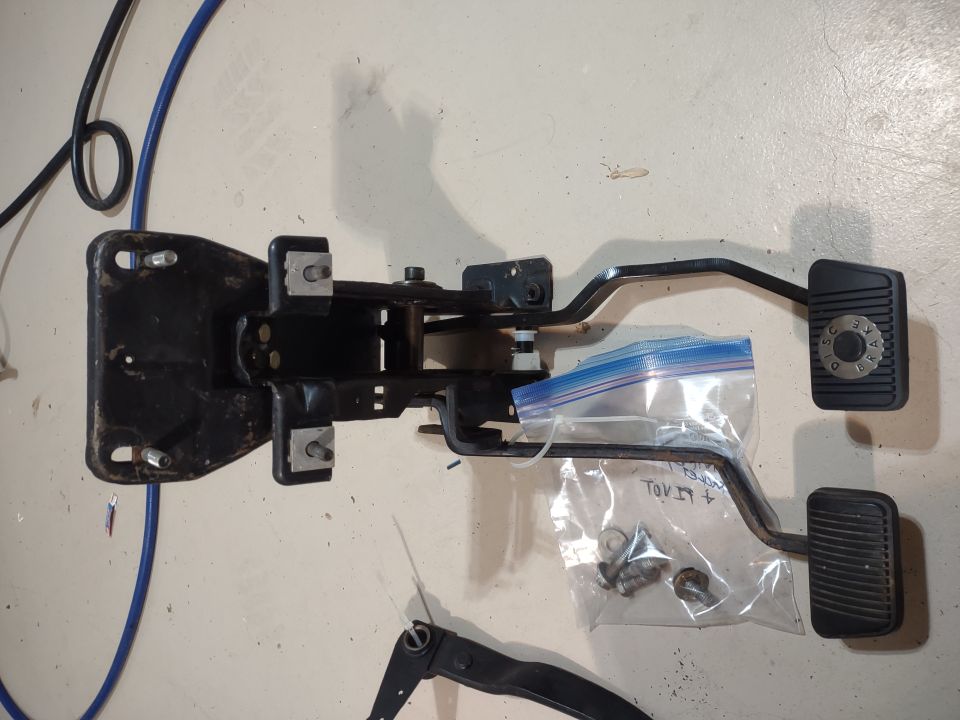 Brake and clutch pedal assembly with mounting bracket and hardware.