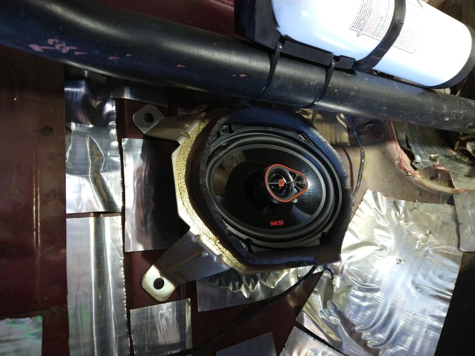 Car speaker installation with sound dampening and fire extinguisher