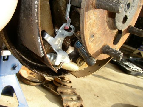 1995 Ford Bronco - A close-up view of a vehicle's brake drum assembly, revealing worn brake shoes and springs.