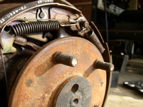 1995 Ford Bronco - Close-up of a rusty brake drum assembly with visible brake shoes and springs. Part number 79-4330-ER is visible.