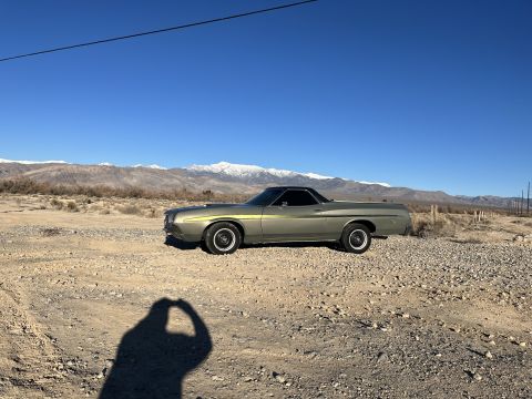 1972 Ford Ranchero - A 1972 Ford Ranchero sits in a dusty, arid landscape under a clear blue sky.