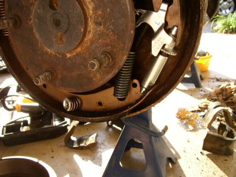 1995 Ford Bronco - This photo shows a close-up view of a vehicle's brake drum assembly, including springs and a brake cylinder.