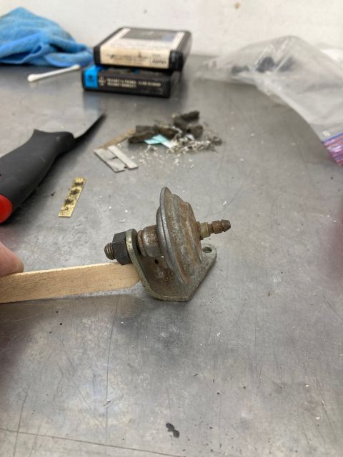 1968 Mercury Cougar - A close-up of a worn fuel pump sits on a workbench next to various tools and debris.
