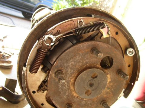 1995 Ford Bronco - Drum brake assembly showing wear and rust on components.