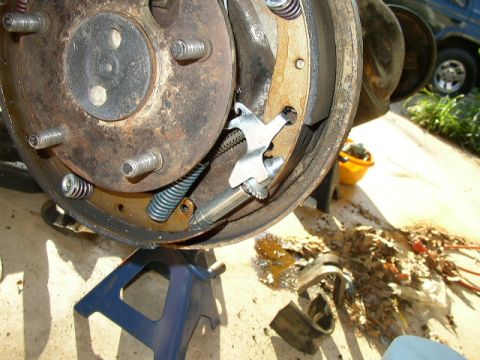 1995 Ford Bronco - This photo shows a close-up of a vehicle's drum brake assembly, with a dark SUV in the background.