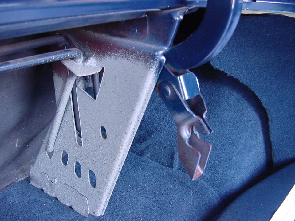 In this view, you can see the broken bar was removed from the catch on the right side, and since it was the left side that broke, it was all removed.  The grabber hook was pulled down so that the trunk would still close ok.  The bar that remained still helped "a little" with raising and closing the trunk.