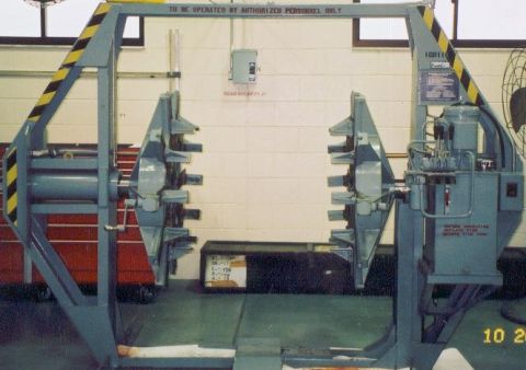 1988 Ford Bronco - Industrial tire changing machine with warning labels and operational instructions visible.