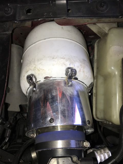 2000 Ford Explorer - A custom intake system is installed in the engine bay, featuring a white cylindrical air filter housing connected to a chrome funnel and bl…