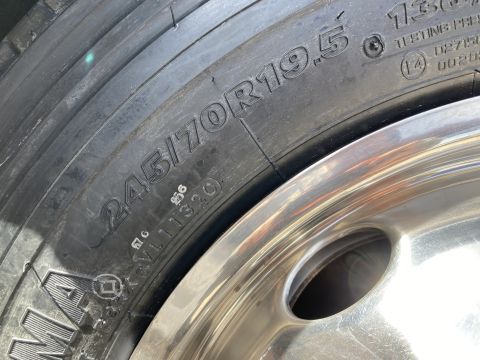 2015 Ford F-550 - Close-up of a tire with the size designation 245/70R19.5 clearly visible. The tire is mounted on a shiny chrome wheel.