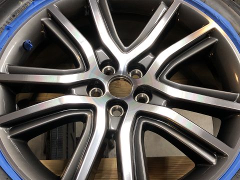 2019 Ford Everest - A close-up view of a dark gray, multi-spoke alloy wheel with a polished lip. Blue painter's tape is visible around the edge of the tire.