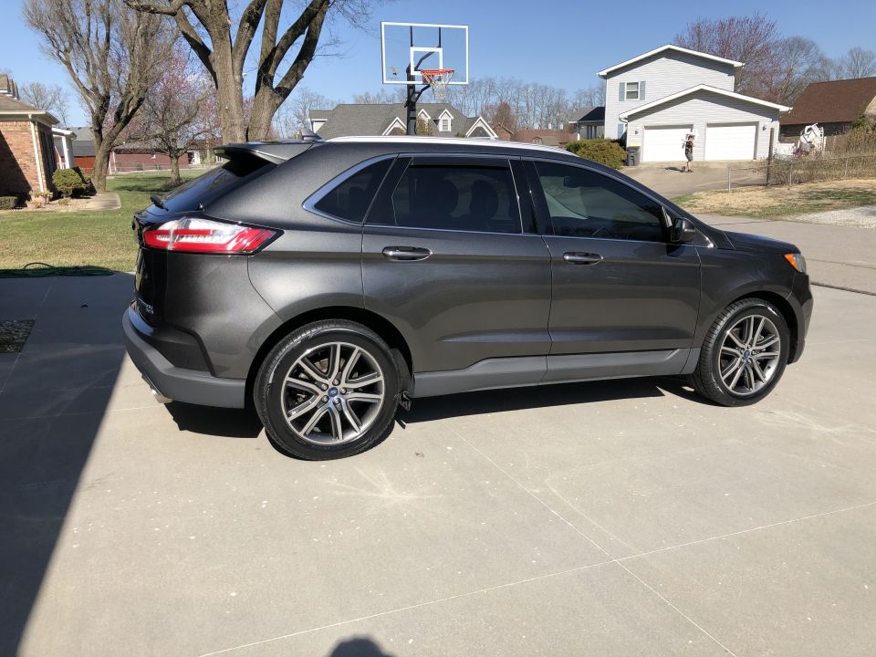 Dark gray 2019 Ford Edge SUV parked on a concrete driveway.