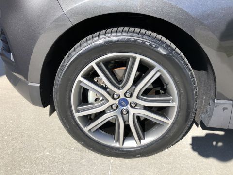 2019 Ford Everest - Close-up of a gray SUV's wheel, a polished multi-spoke rim with a Ford emblem.