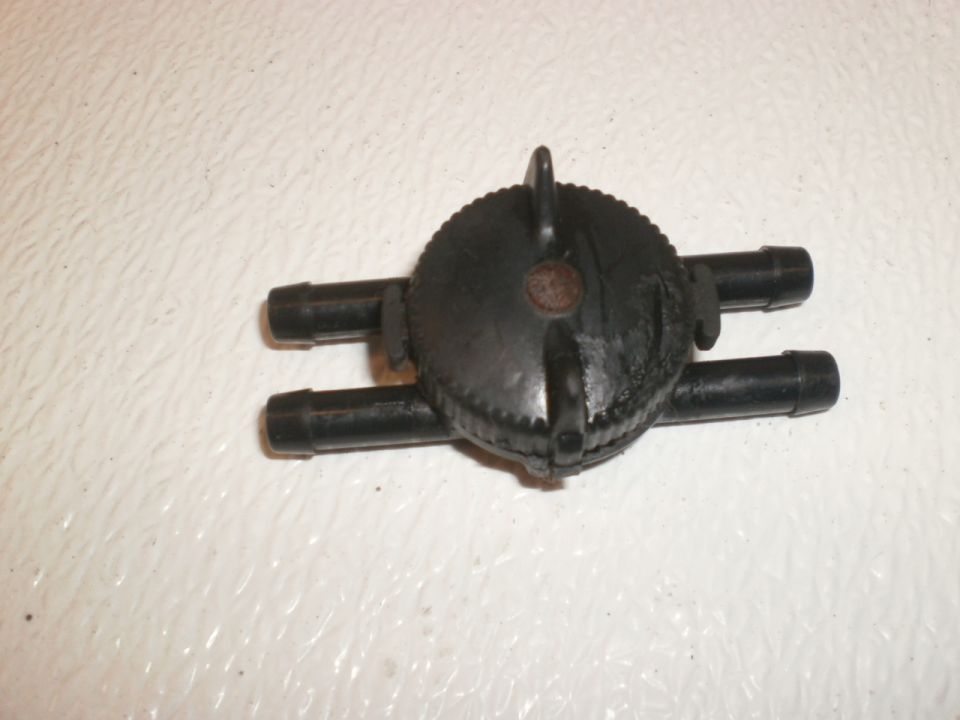 This is the headlight door vacuum shutoff switch, which is used when you want the headlight doors to stay open while you change or aim the headlights.