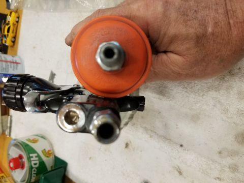 1973 Chevrolet Camaro - Close-up of a spray gun regulator being held by a hand.