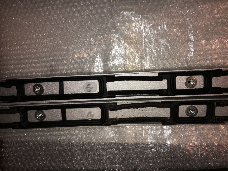 Pair of black roof rack crossbars with silver mounting points