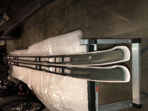 2019 Ford Everest - Two roof rack rails are packaged for transport, with visible foam padding and mounting hardware.