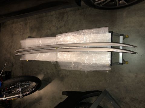 2019 Ford Everest - Pair of silver roof rack rails, packaged for transport or storage.