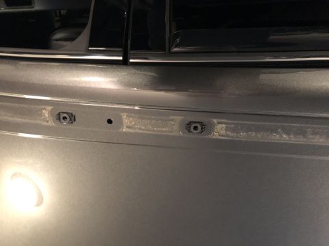 2019 Ford Everest - Close-up of a gray SUV's rear bumper, showing mounting points for a roof rack.