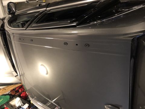 2019 Ford Everest - Close-up of a gray SUV's side panel, showing pre-drilled holes for accessory mounting.