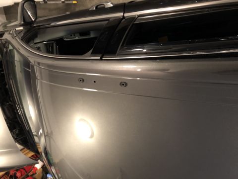 2019 Ford Everest - Side panel of a gray SUV showing mounting points where a roof rack would attach.