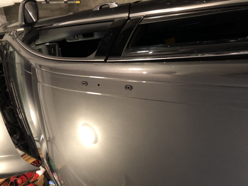 Gray SUV side panel with mounting holes for roof rack