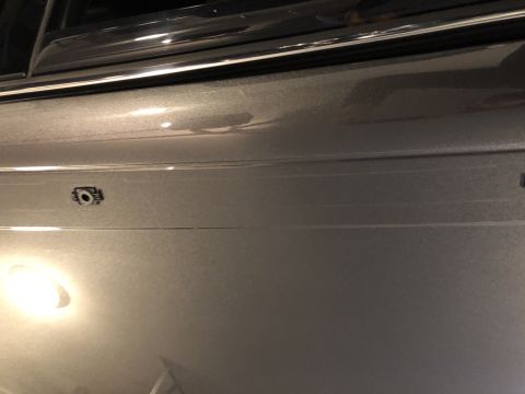 2019 Ford Everest - A close-up shot of a vehicle's side panel reveals a small camera, possibly for parking assistance or a 360-degree view.