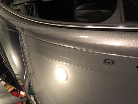 2019 Ford Everest - Close-up of a gray rear bumper, showing a camera housing and chrome trim detail.