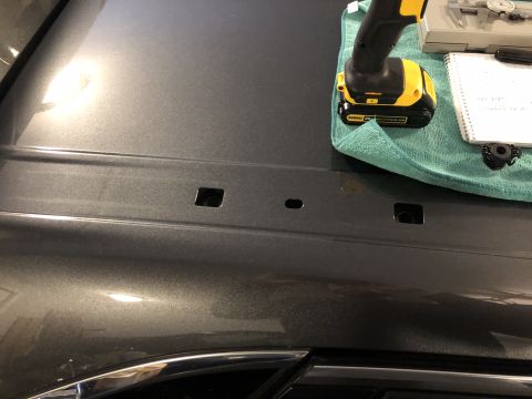 2019 Ford Everest - Tools laid out on a car hood, possibly for a repair or modification.