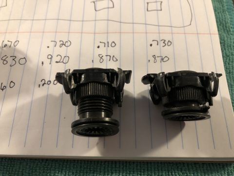 2019 Ford Everest - Two black plastic automotive parts are shown with handwritten measurements on lined paper, possibly for comparison or specification.