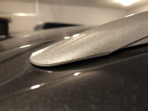 2019 Ford Everest - Detail of a silver roof rack component attached to a dark vehicle's roof.