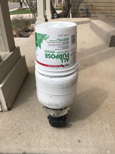 2000 Ford Explorer - A white bucket labeled 'All Purpose Joint Compound' sits atop another white bucket on a concrete porch.