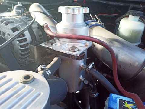 2001 Ford Excursion - Engine bay details with various hoses and metal components visible.