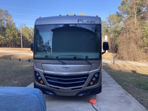 2015 Ford F-550 - Front view of a tan motorhome with the "FLAIR" badge visible on the windshield header.
