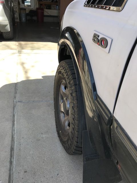 2000 Ford Explorer - A white SUV's side view shows a '50' badge on the fender, with another vehicle visible in the background.