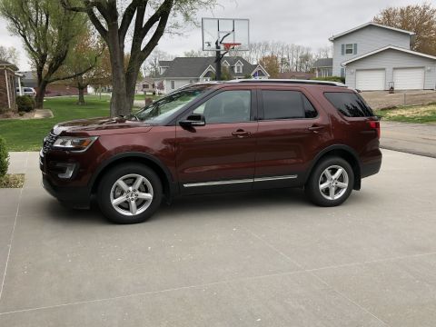 2016 Ford Explorer - This maroon 2016 Ford Explorer is shown from the side in a suburban driveway.