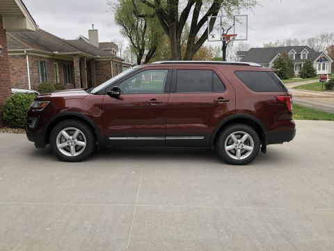 2016 Ford Explorer - Maroon 2016 Ford Explorer parked in front of a brick house with a basketball hoop in the background.
