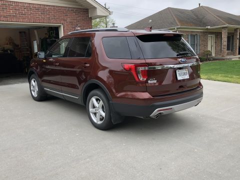 2016 Ford Explorer - This maroon 2016 Ford Explorer is parked in a driveway, showing its rear profile and license plate.