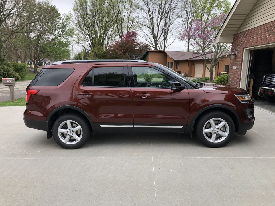 Side view of a red Ford Explorer parked in a driveway