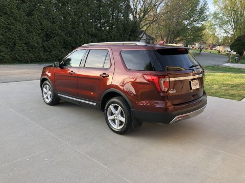 2016 Ford Explorer - This 2016 Ford Explorer is shown in a rear three-quarter view, parked on a concrete driveway.