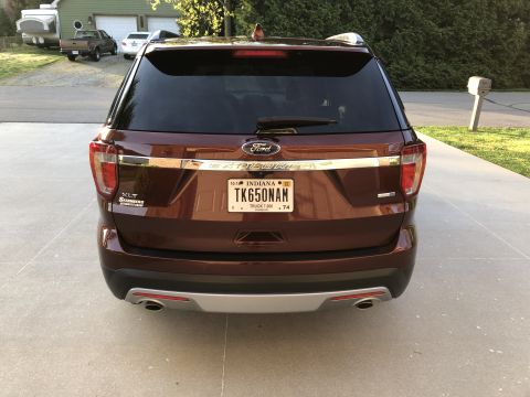 2016 Ford Explorer - The rear of a maroon Ford Explorer SUV is shown parked in a driveway.