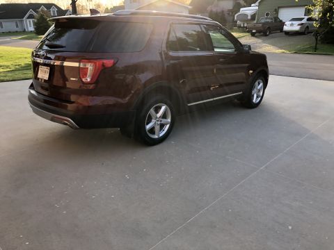 2016 Ford Explorer - This 2016 Ford Explorer is seen from the rear 3/4 angle, parked on a concrete driveway during daylight.