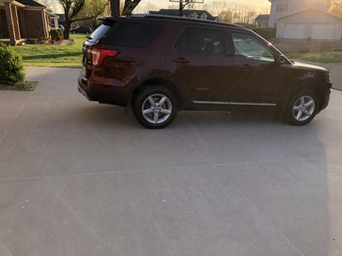 2016 Ford Explorer - Maroon 2016 Ford Explorer parked on a driveway in front of a house.
