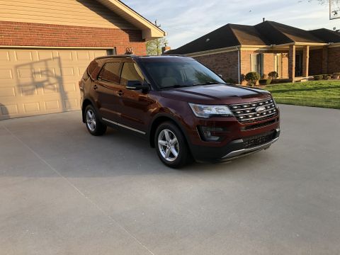 2016 Ford Explorer - This maroon 2016 Ford Explorer is parked in a suburban driveway in front of a brick house.