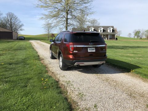 2016 Ford Explorer - A brown Ford Explorer is parked on a gravel driveway leading to a house and barn.
