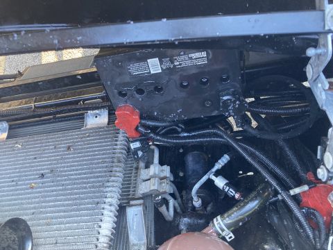 2015 Ford F-550 - Close-up view of a vehicle's battery and radiator assembly, showing various engine components and wiring.