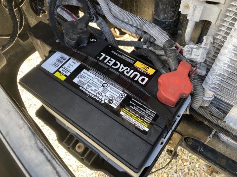 2015 Ford F-550 - Close-up view of a Duracell car battery, showing its labeling and terminal connections.