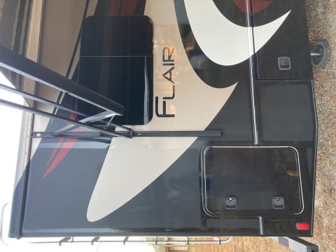 2015 Ford F-550 - The side of a recreational vehicle shows the 'FLAIR' model name and an extended awning.