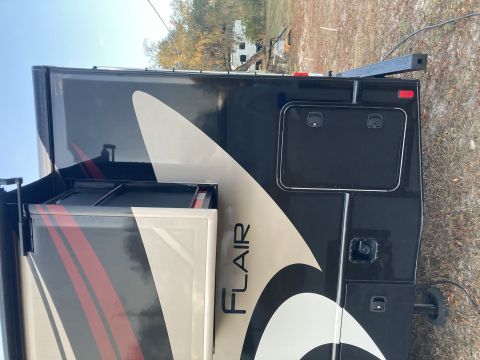 2015 Ford F-550 - The side of a recreational vehicle shows the 'FLAIR' branding and various exterior compartments.
