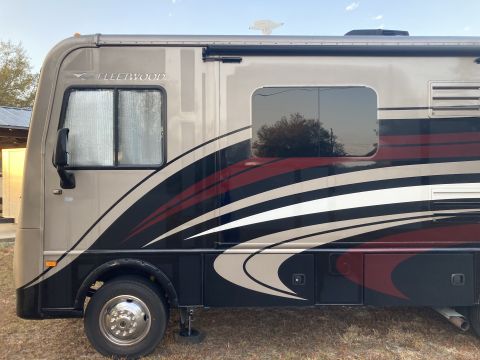 2015 Ford F-550 - This motorhome features a side view with distinctive graphics and Fleetwood badging, but its year is not discernible from the image.